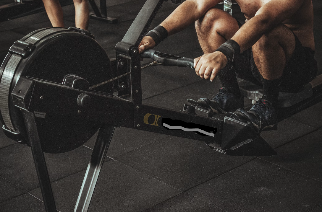 Mann am Rudergerät im Fitnessstuio